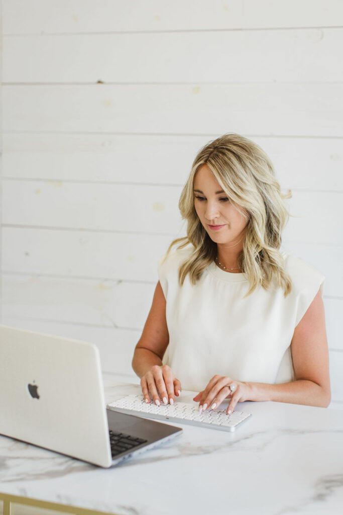 Woman working on a computer analyzing programmatic ads and CTV ads.