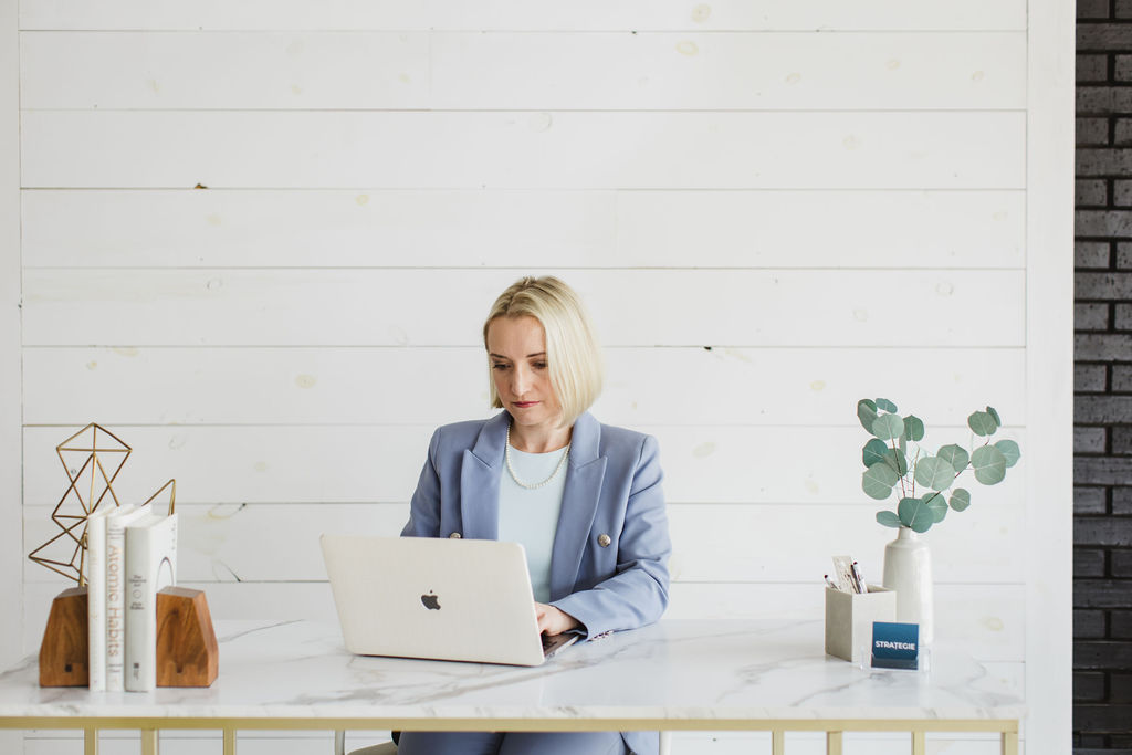 Person working on a computer designing and reviewing a website.