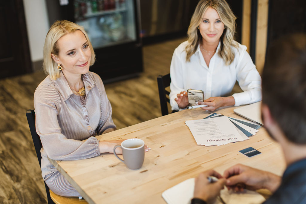 Marketing professionals consulting with a client to align on business strategy and next marketing steps.