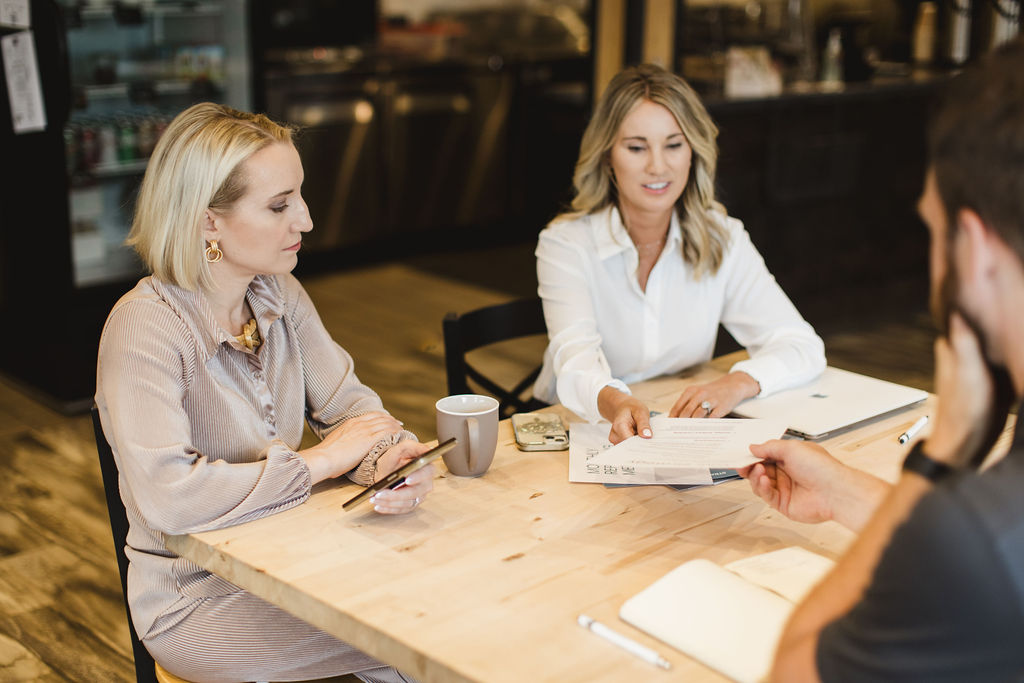 Marketing professionals meeting with a client to discuss strategy and business goals.