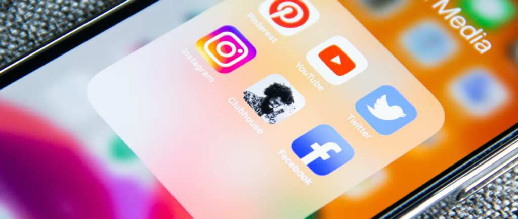 Close-up of a phone screen showing a folder of social media apps.